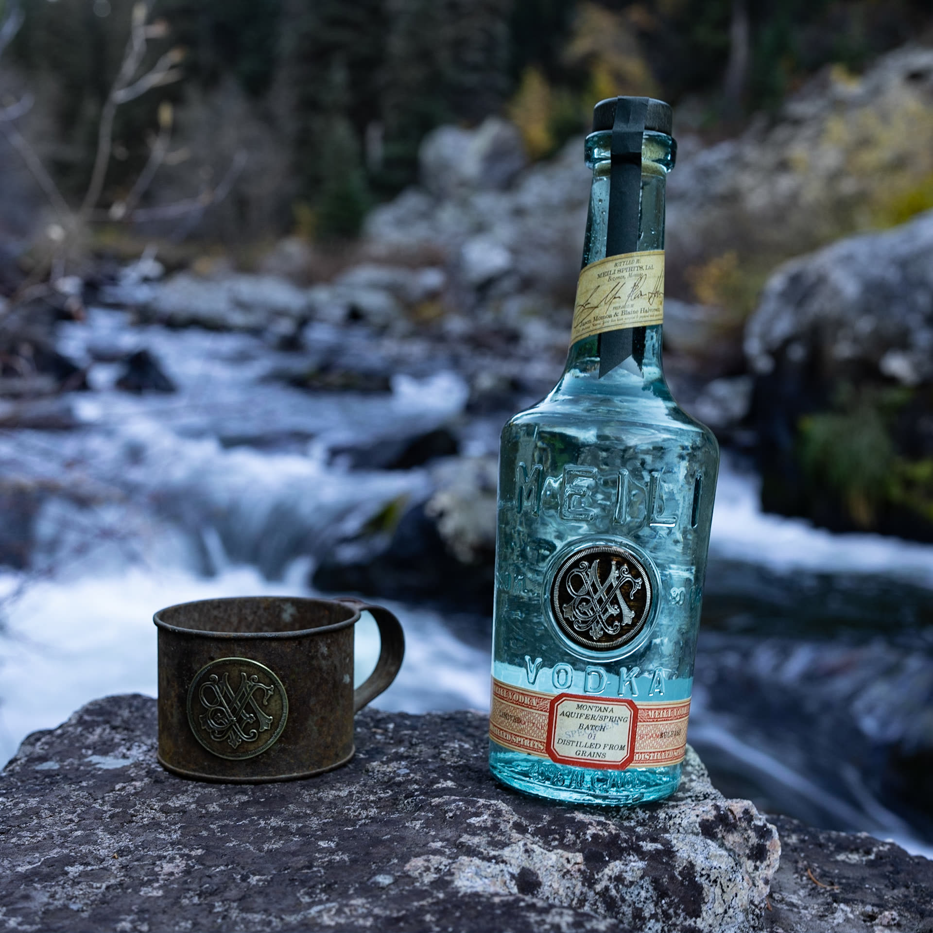 Meili bottle beside a Montana river